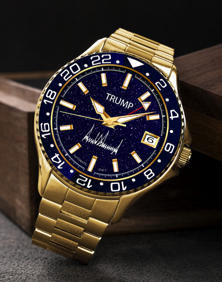 Gold Trump wristwatch with blue starry dial, date display, and signature on a dark background.