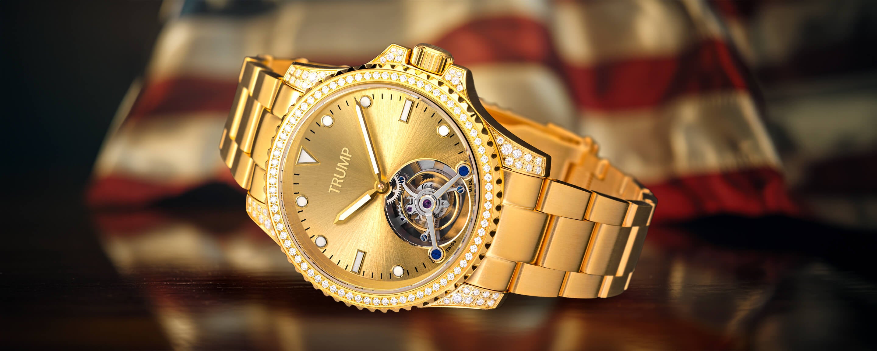 Gold Trump wristwatch with diamond bezel, open tourbillon design, and metallic link bracelet.