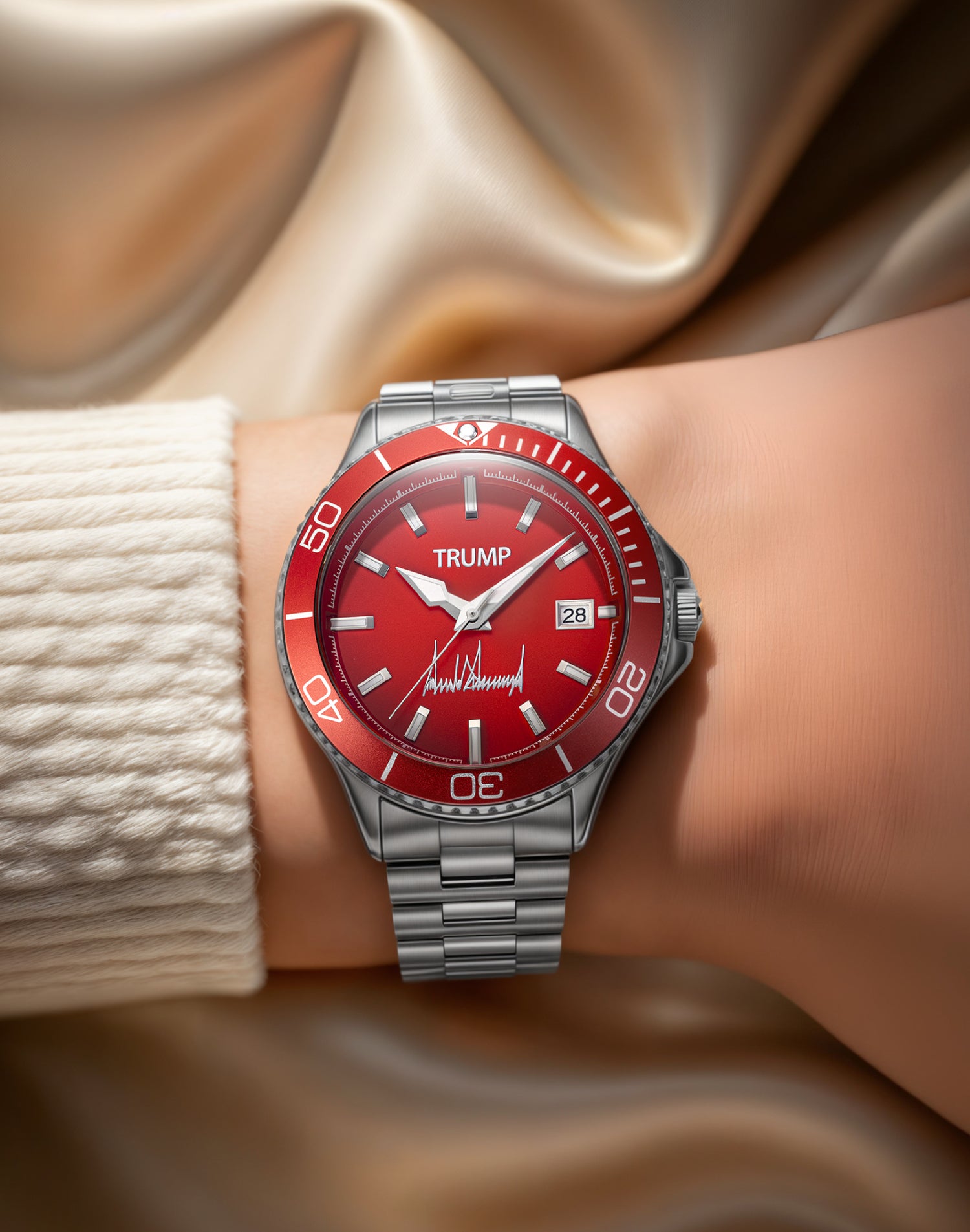 Red Trump wristwatch with date display and metal band on wrist, satin fabric background.