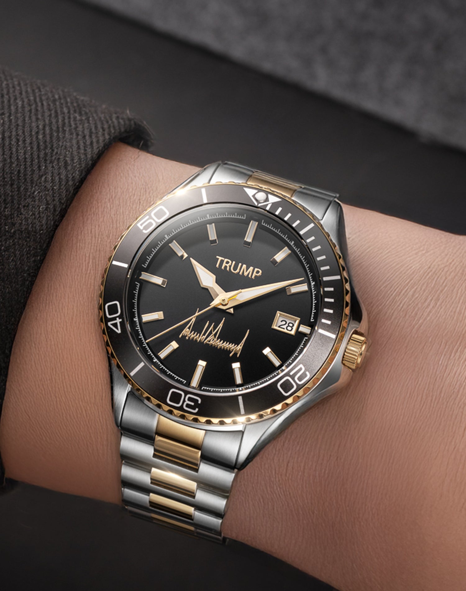 Two-tone Trump wristwatch with black dial, date display, and gold accents on a stainless band.