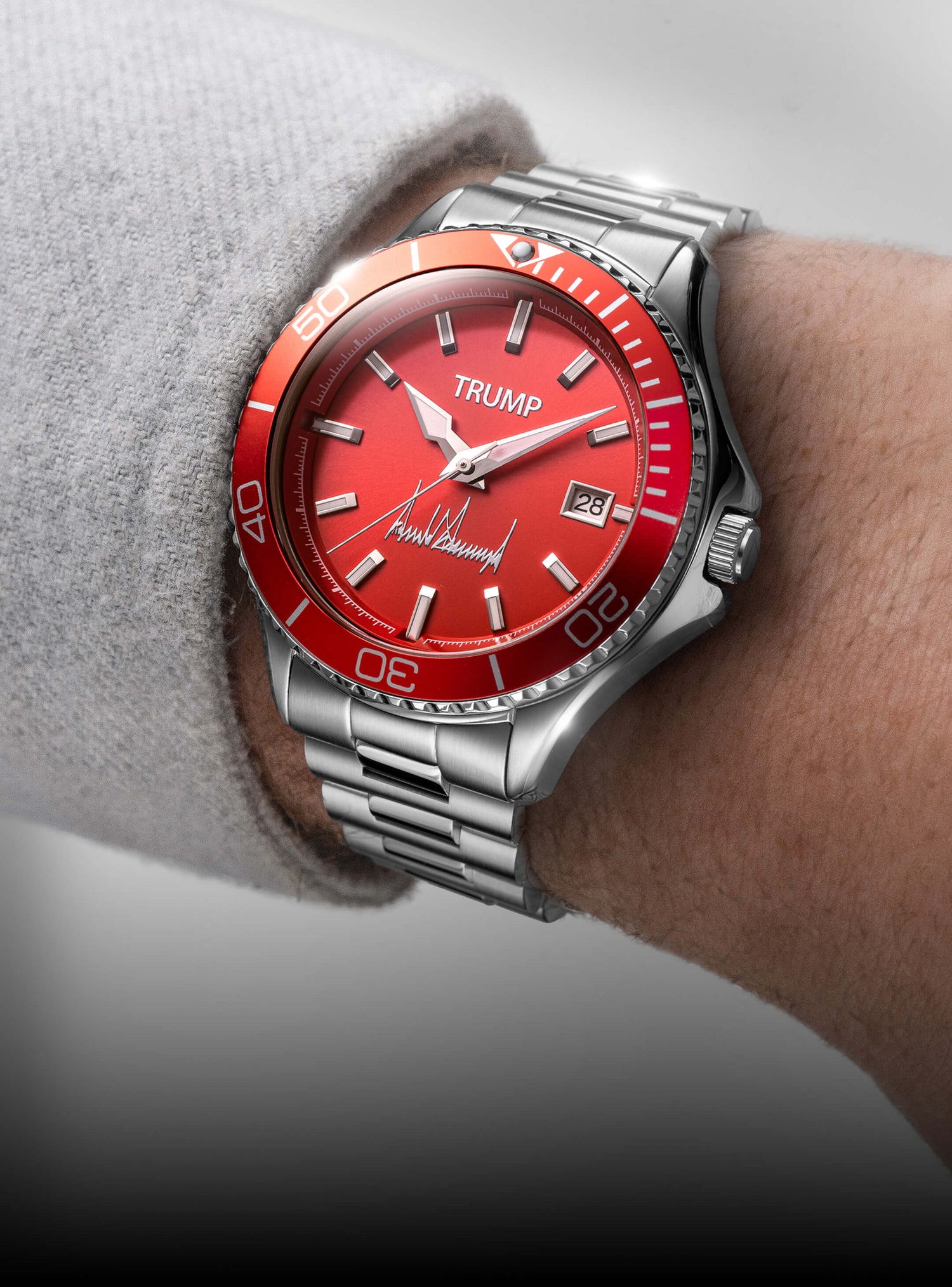 Red Trump wristwatch with stainless steel band, date display, and signature on dial.