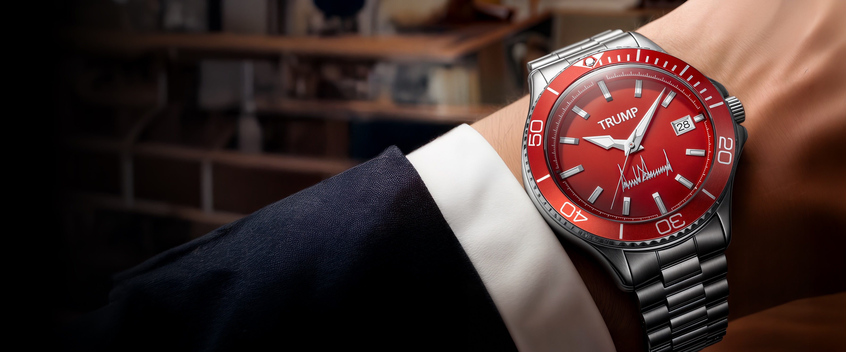 Red Trump-branded wristwatch with silver metal band and date display worn with dark suit.