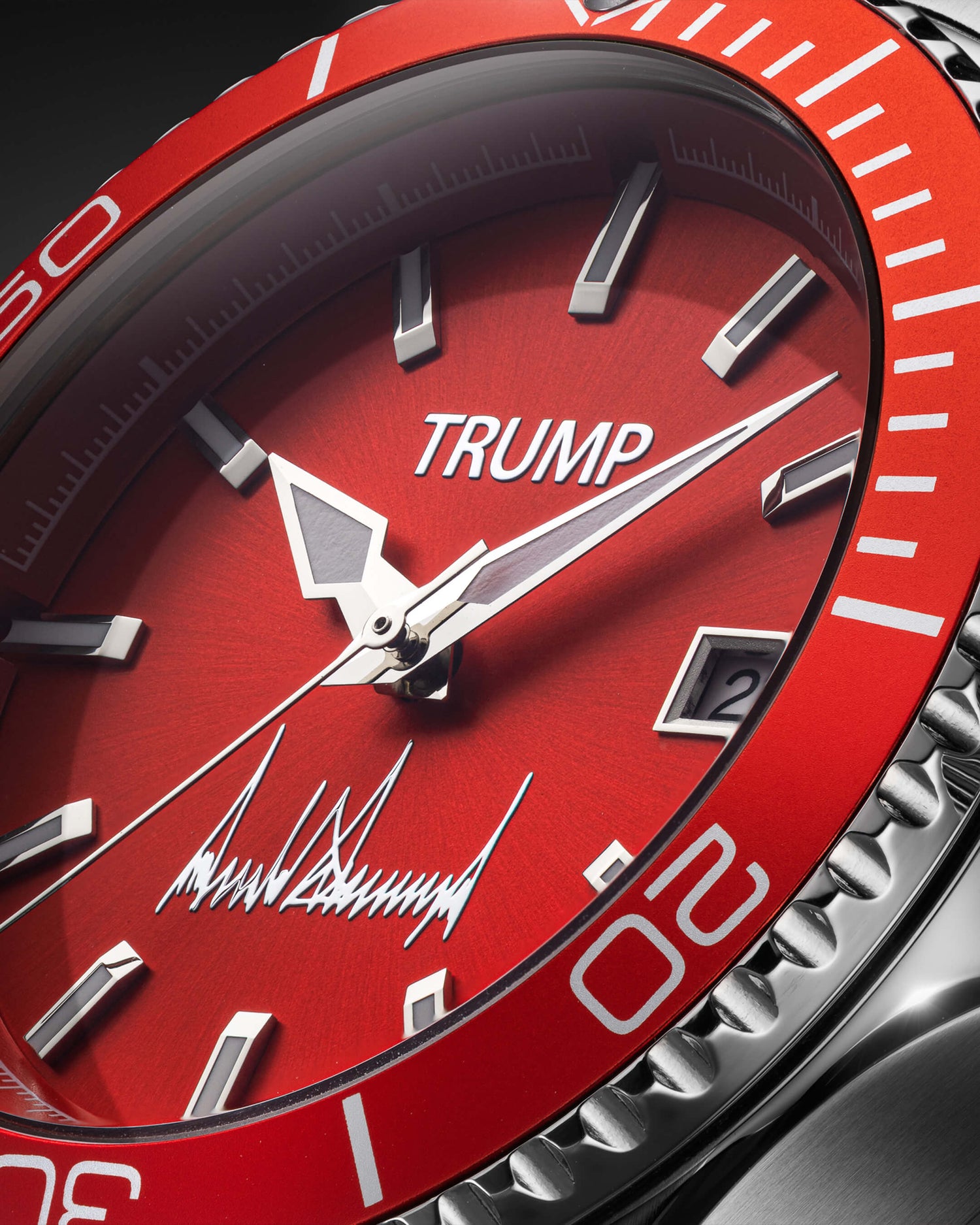 Red TRUMP wristwatch with silver indices, bold hands, bezel markings, and signature on dial.