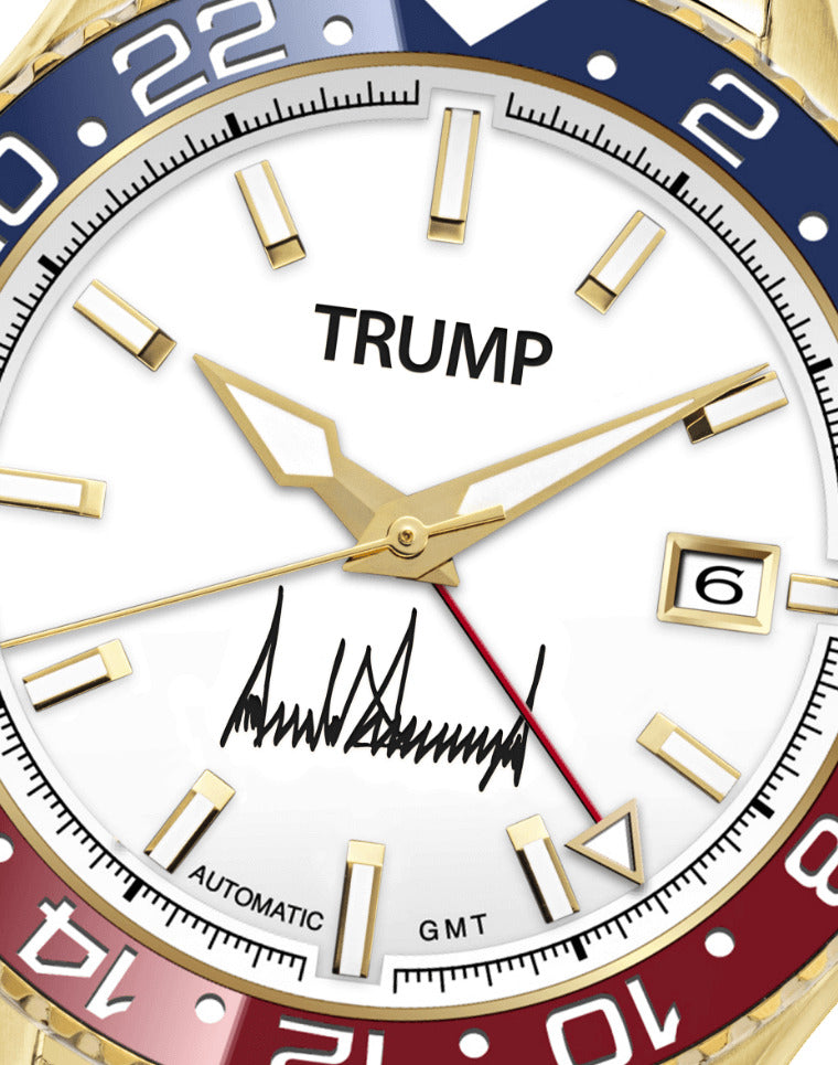 Gold Trump-branded GMT watch with white dial, red-blue bezel, and signature on face