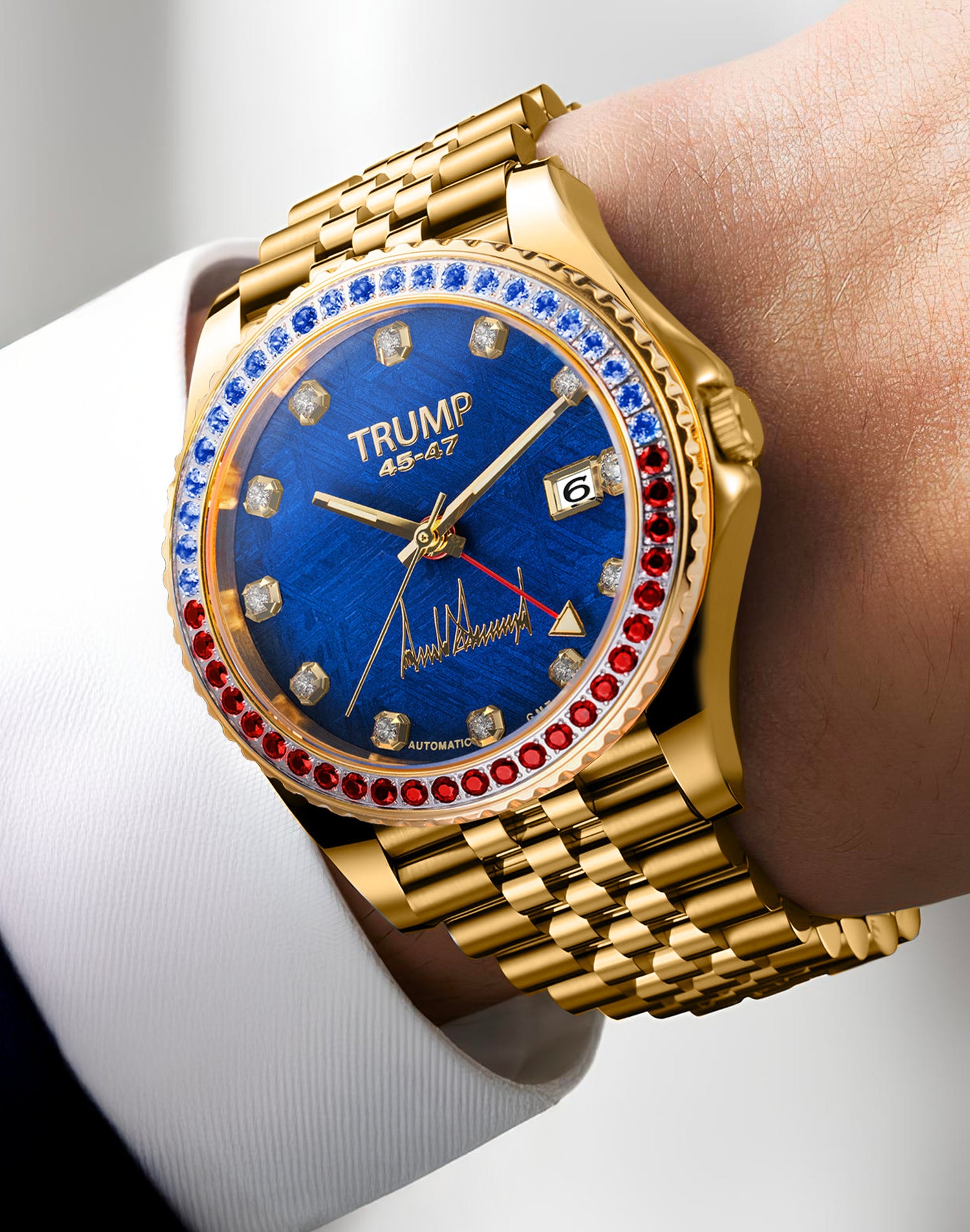 Gold wristwatch with blue face, diamond markers, and red, white, and blue gemstone bezel.