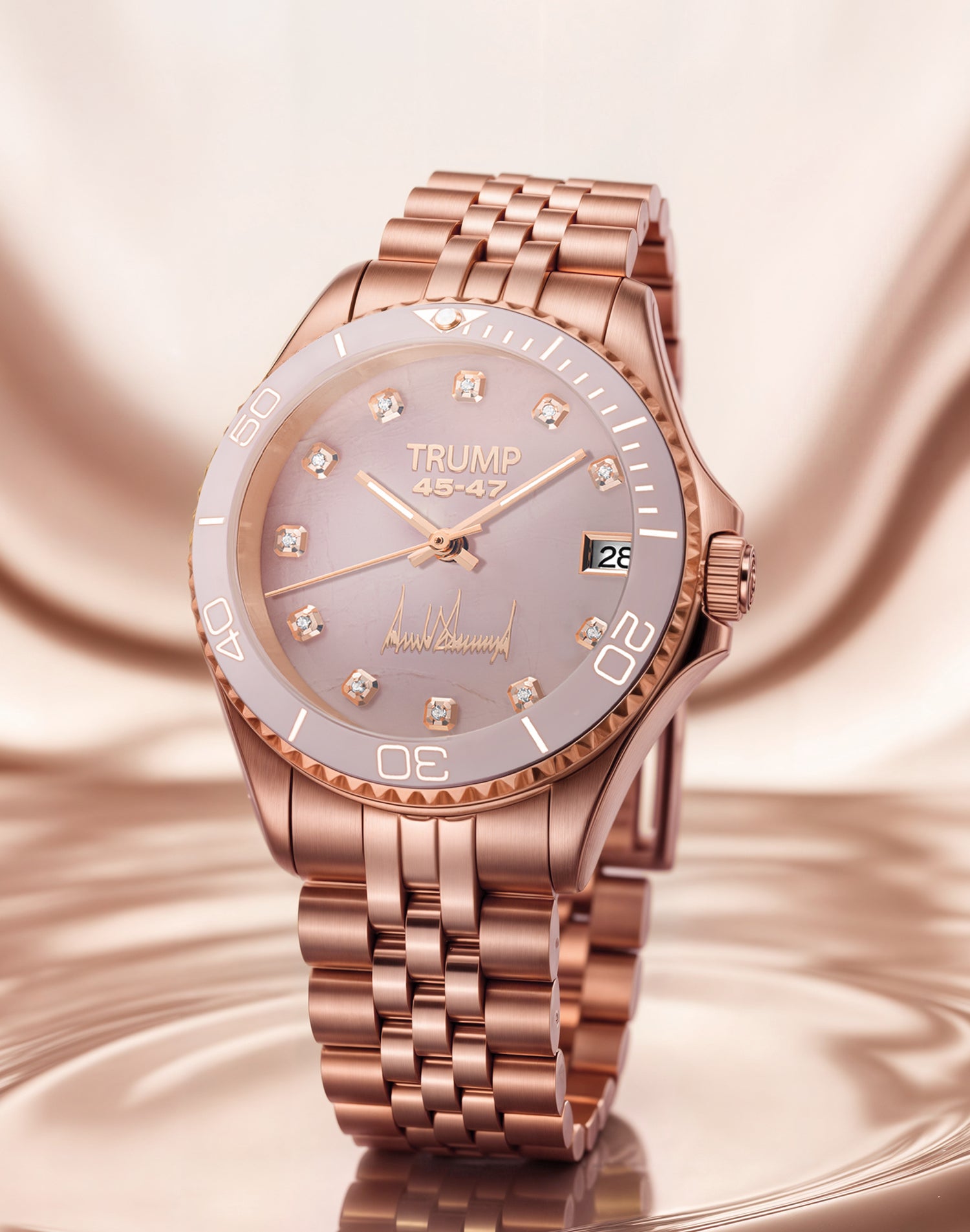 Rose gold Trump wristwatch with diamond hour markers, date display, and linked metal band.