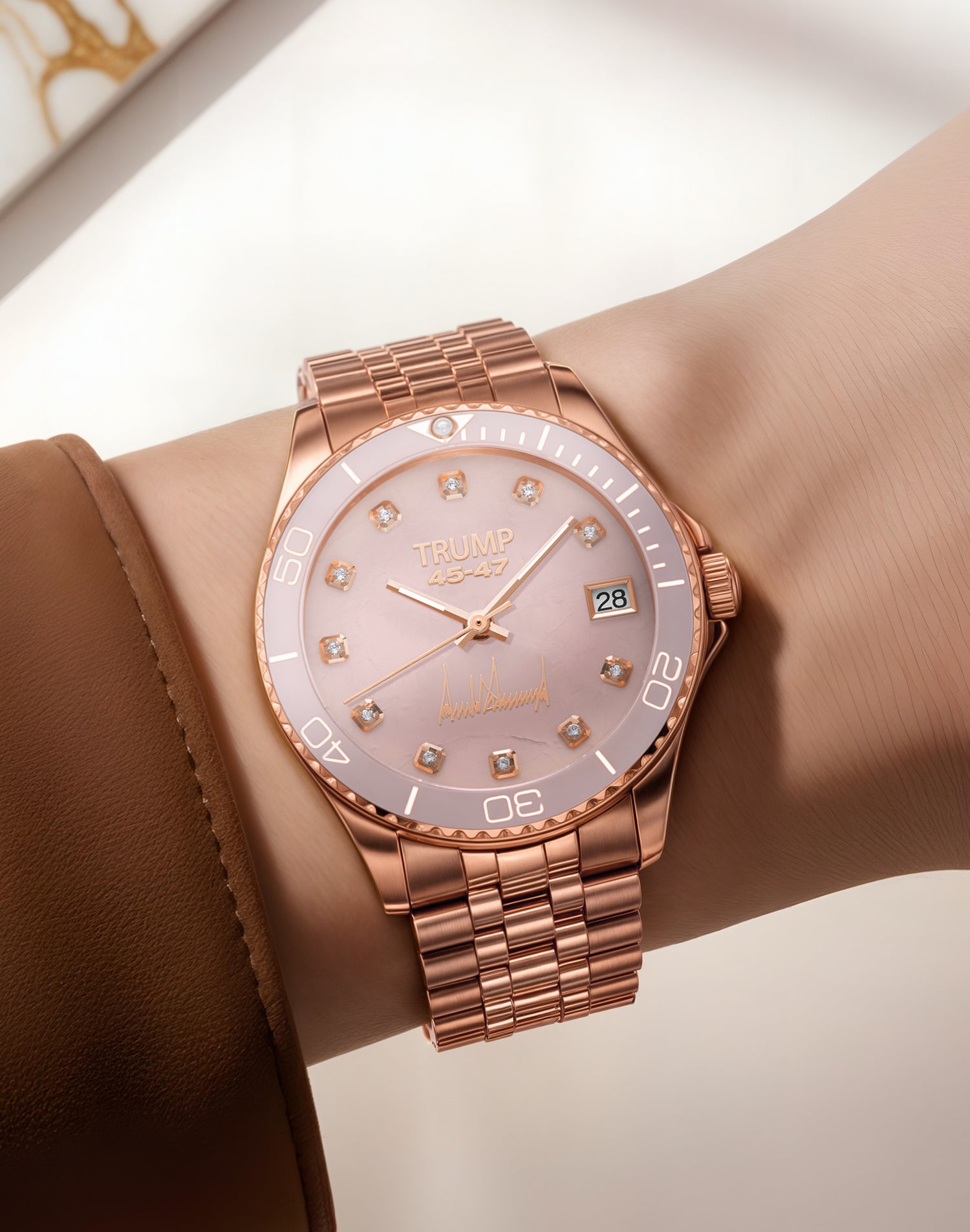 Rose gold Trump 45-47 wristwatch with diamond markers and date display on a wrist