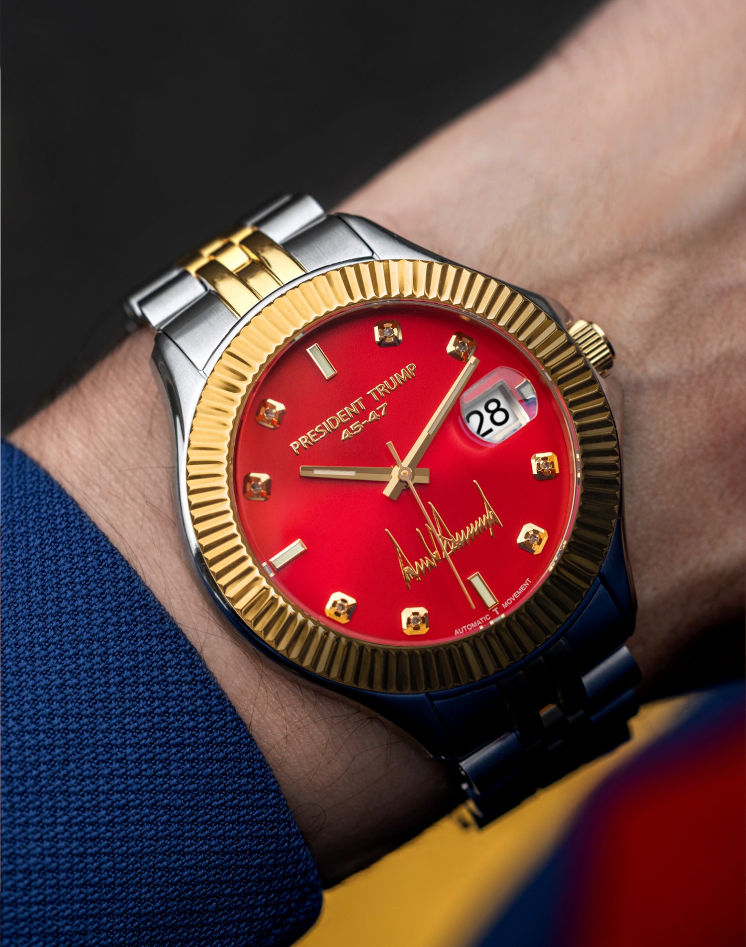 Two-tone wristwatch with red dial, gold bezel, and "President Trump" branding on a man's wrist