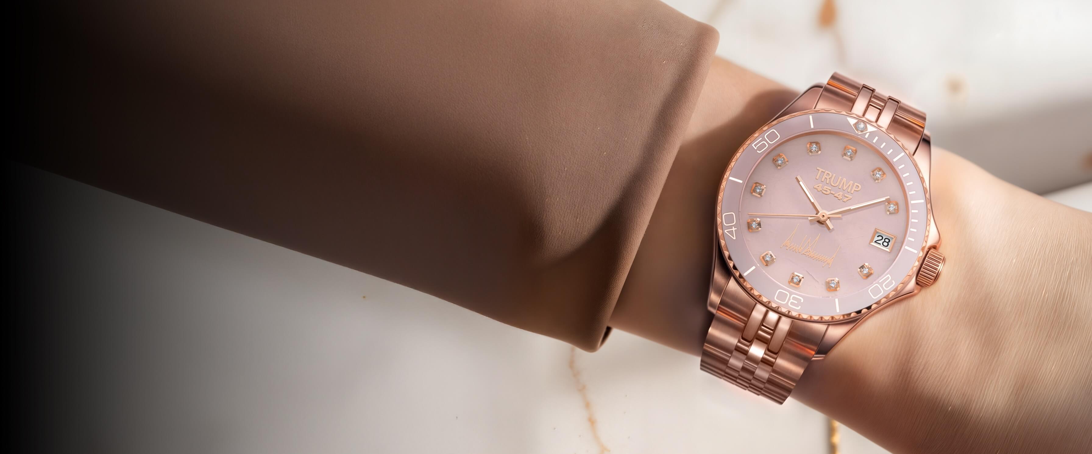 Rose gold Trump 45-47 wristwatch with diamond hour markers and date display on woman's wrist