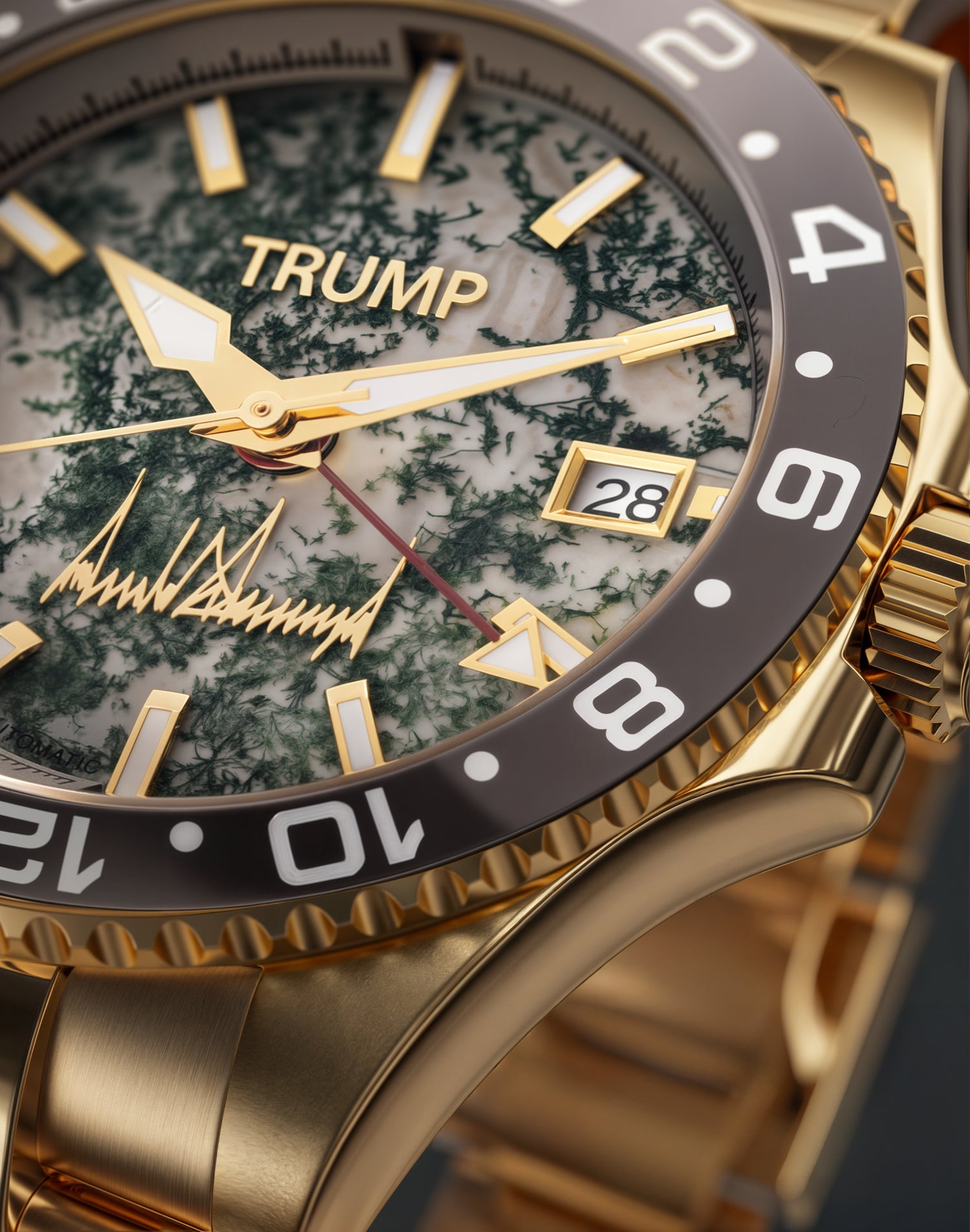 Gold Trump wristwatch with marble-patterned dial, date display, and black rotating bezel.