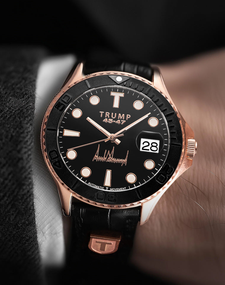 Black and gold Trump 45-47 wristwatch with leather strap, bold markers, and date display.