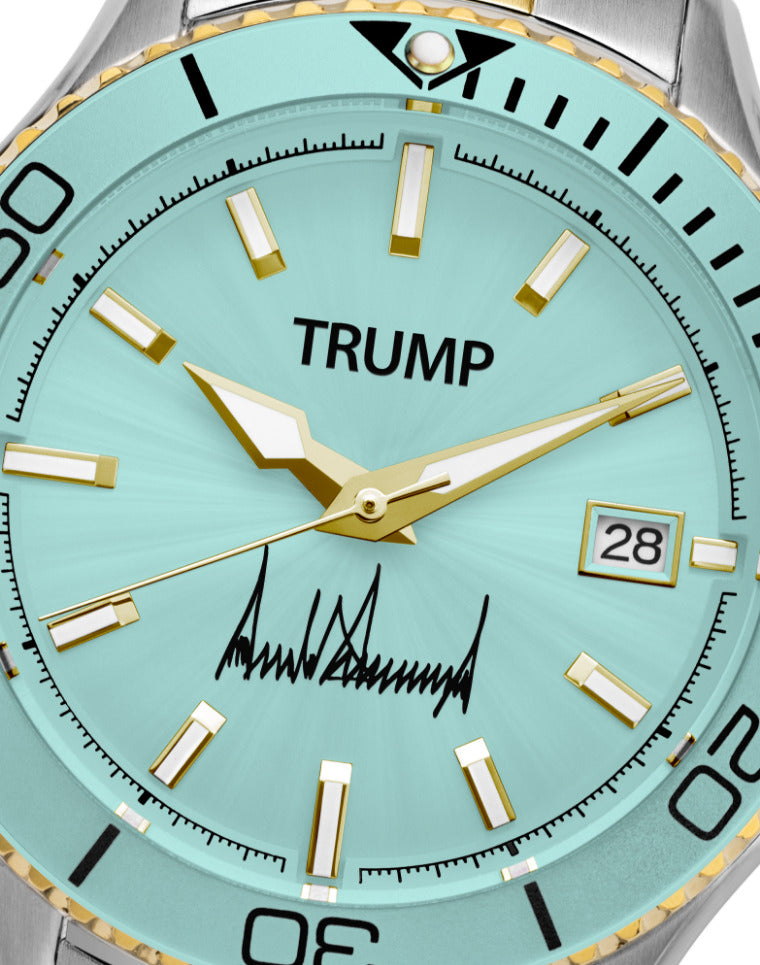 Mint green Trump wristwatch with gold accents, date display, and signature on dial face.
