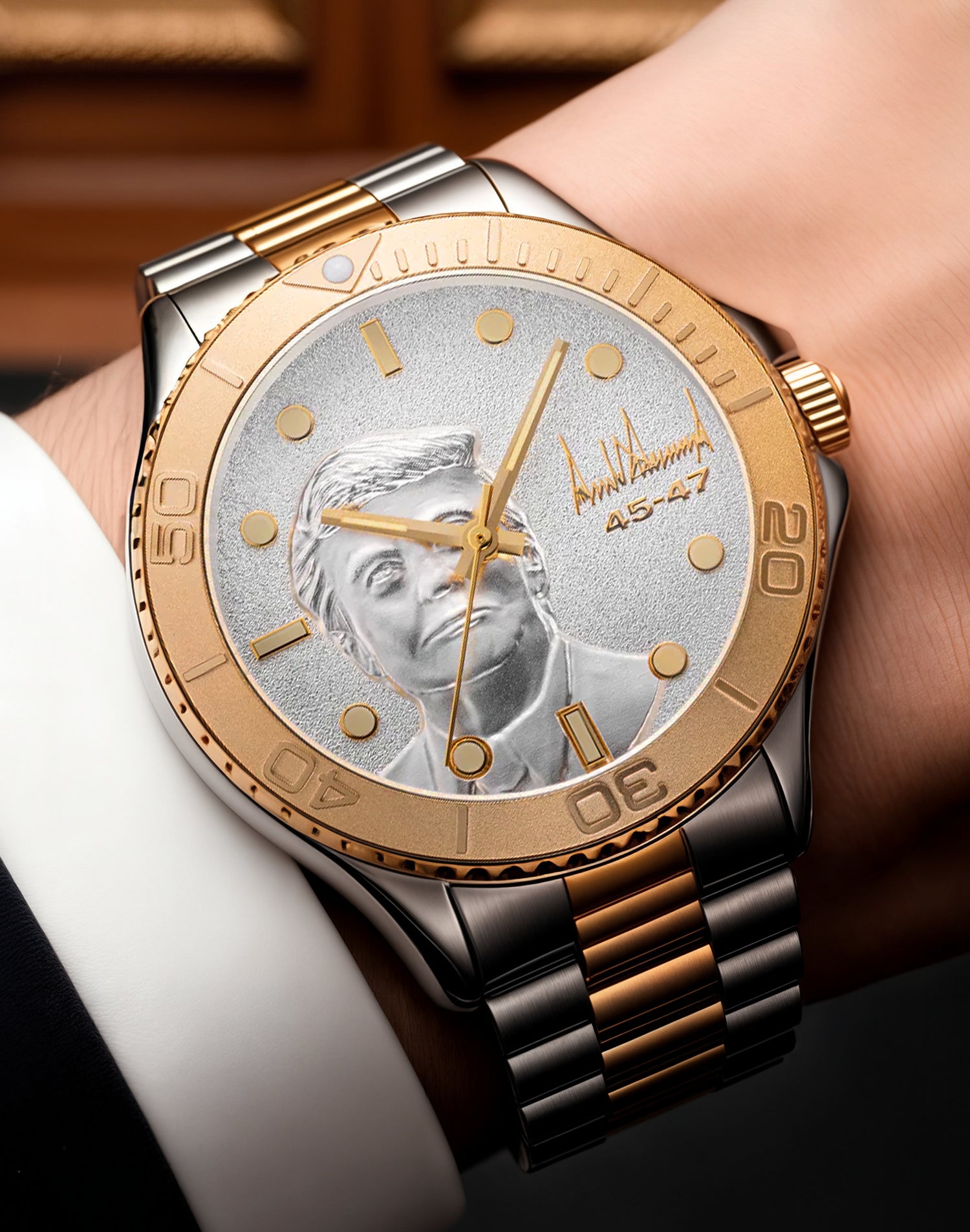 Two-tone gold and silver wristwatch with engraved face and signature on textured dial.