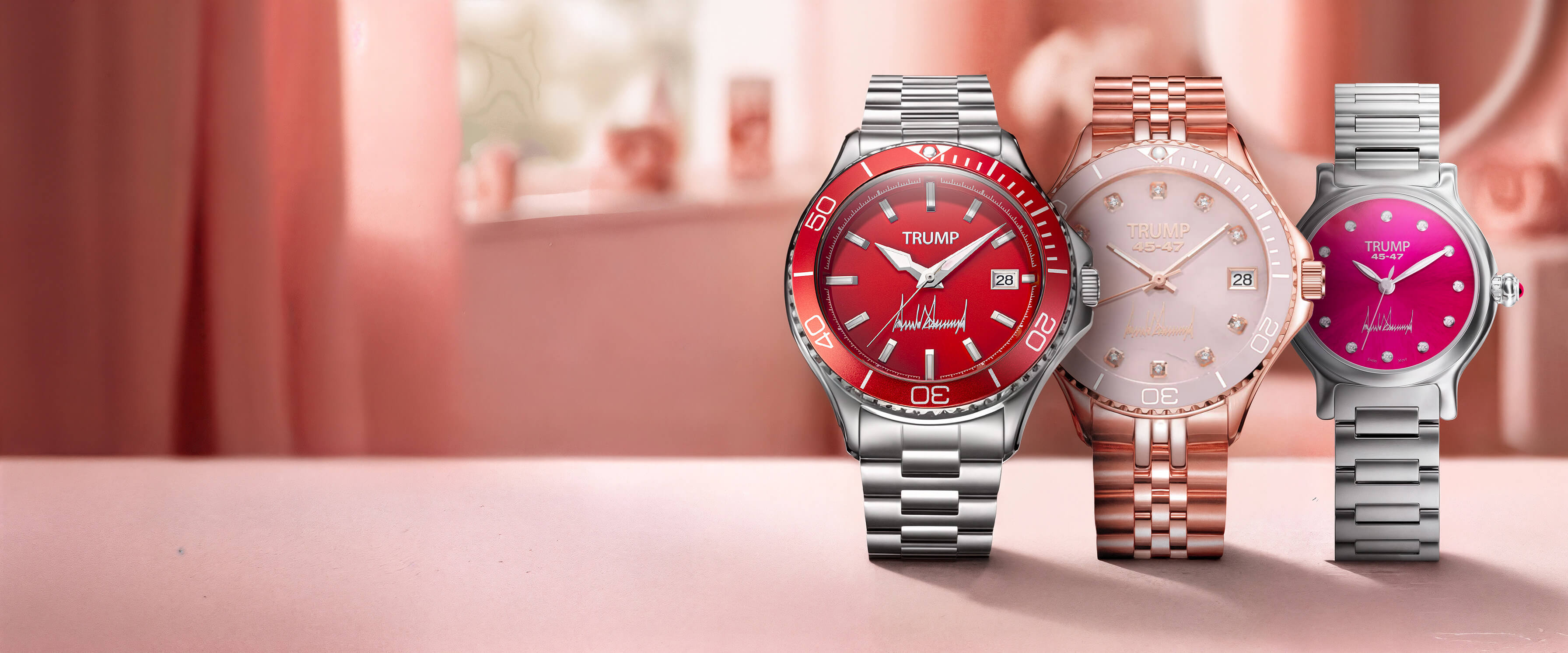 Three Trump wristwatches with red, pink, and rose gold dials displayed on a pink surface.